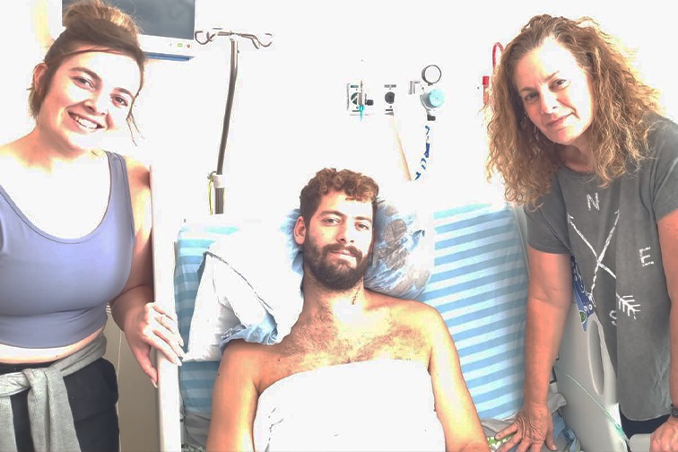 Sela in the hospital with his mom and sister