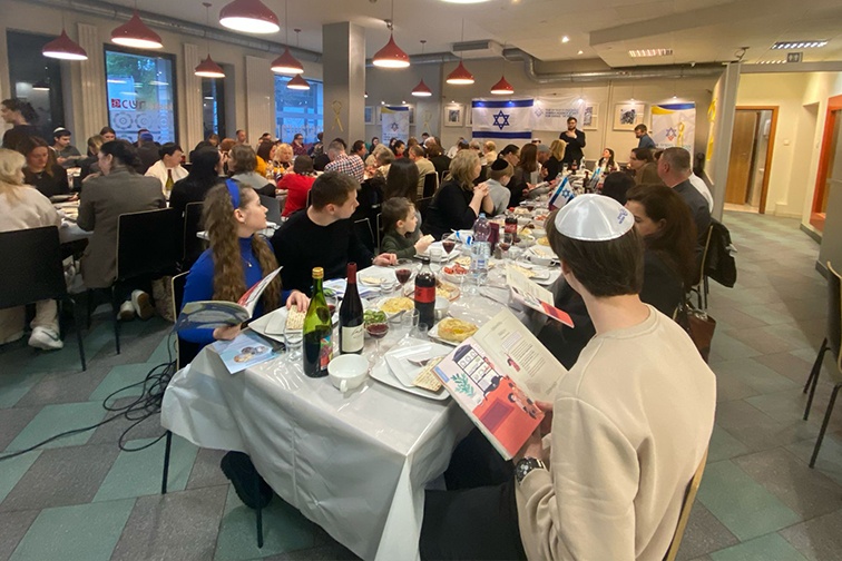 Ukrainian Jewish refugees sit at a Seder table in Poland